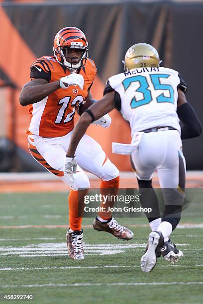 Demetrius McCray of the Jacksonville Jaguars attempts to tackle Mohamed Sanu of the Cincinnati Bengals during the third quarter at Paul Brown Stadium...