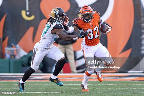 Jeremy Hill of the Cincinnati Bengals stiff arms Tommie Campbell of the Jacksonville Jaguars during the third quarter at Paul Brown Stadium on...