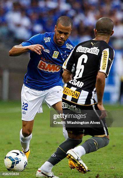Mayke of Cruzeiro struggles for the ball with Junior Cesar of Botafogo during a match between Cruzeiro and Botafogo as part of Brasileirao Series A...