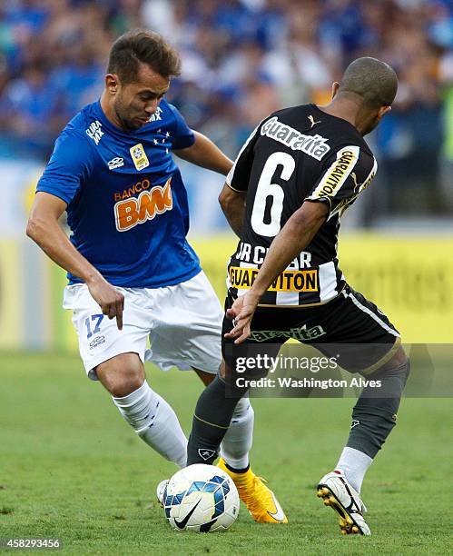 Everton Ribeiro Junior Cesar#6 of Cruzeiro struggles for the ball with Junior Cesar of Botafogo during a match between Cruzeiro and Botafogo as part...