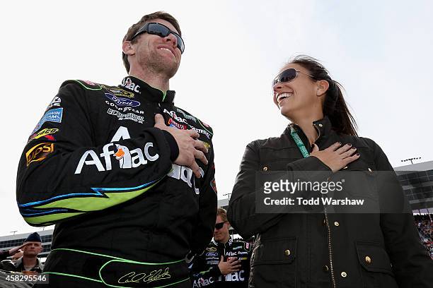 Carl Edwards, driver of the Aflac Ford, and his wife Kate stands on the grid during pre-race ceremonies for the NASCAR Sprint Cup Series AAA Texas...