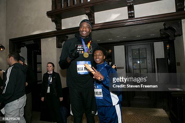Dikembe Mutombo and Jontai Williams finish the last leg of the TCS New York City Marathon as part of the NBA All-Star Relay Team on November 2, 2014...