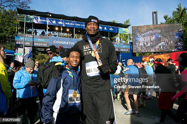 Former NBA player Dikembe Mutombo and Jontai Williams finish the last leg of the TCS New York City Marathon as part of the NBA All-Star Relay Team on...