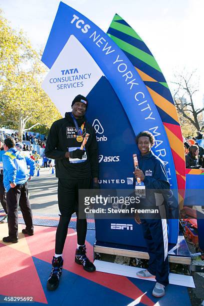 Former NBA player Dikembe Mutombo and Jontai Williams finish the last leg of the TCS New York City Marathon as part of the NBA All-Star Relay Team on...