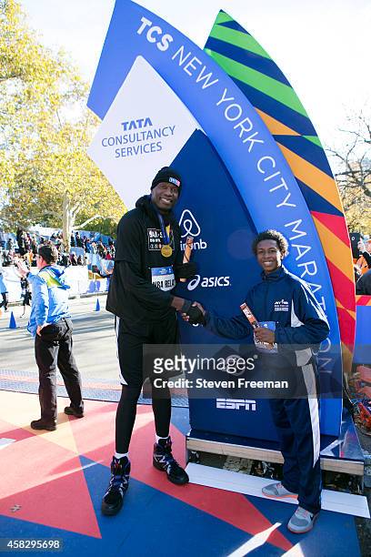 Former NBA player Dikembe Mutombo and Jontai Williams finish the last leg of the TCS New York City Marathon as part of the NBA All-Star Relay Team on...