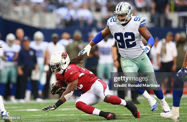 Andre Ellington of the Arizona Cardinals runs the ball against Jeremy Mincey of the Dallas Cowboys in the second quarter at AT&T Stadium on November...