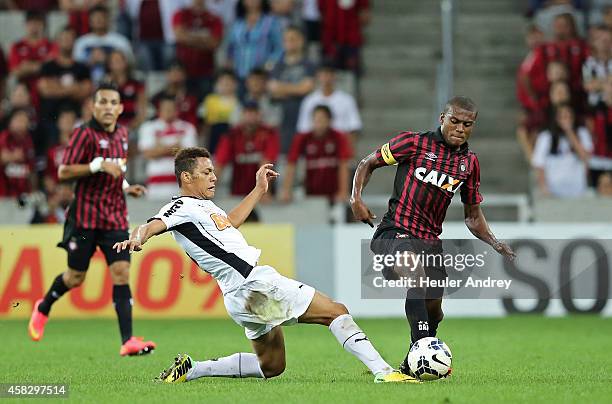 Marcelo of Atletico-PR competes for the ball with Alex Silva of Atletico-MG during the match between Atletico-PR and Atletico-MG for the Brazilian...