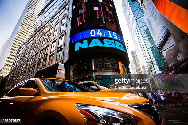 yellow taxi in times square of new york city, manhattan - nasdaq stock pictures, royalty-free photos & images