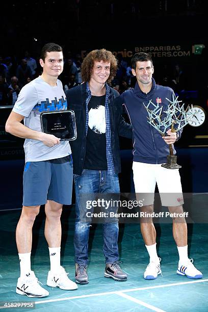 Loser of the final Milos Raonic, Football player David Luiz and winner of the tournament Novak Djokovic attend the Final match during day 7 of the...