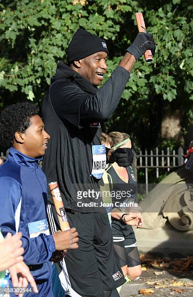 Former NBA star Dikembe Mutombo takes part as the last runner of the NBA Relay during the 2014 New York City Marathon in Central Park on November 2,...