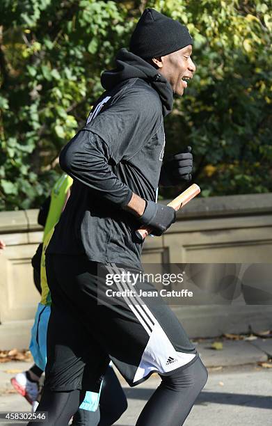 Former NBA star Dikembe Mutombo takes part as the last runner of the NBA Relay during the 2014 New York City Marathon in Central Park on November 2,...