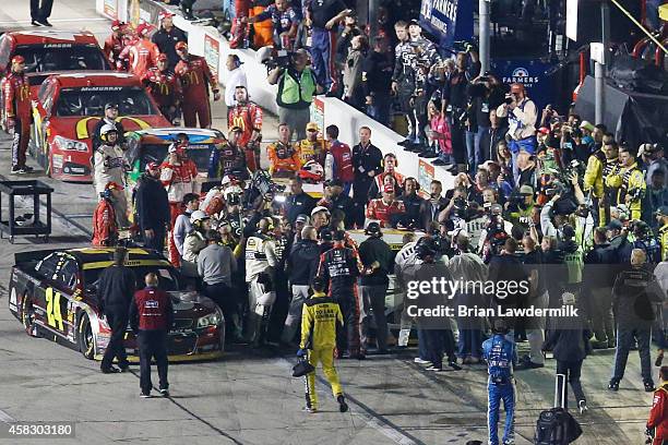 Jeff Gordon, driver of the Drive To End Hunger Chevrolet, walks to confront Brad Keselowski, driver of the Miller Lite Ford, following the NASCAR...