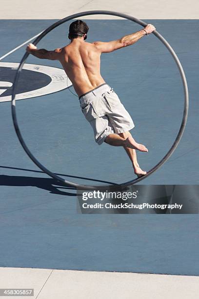 cyr wheel acrobat performer - hoop rolling stock pictures, royalty-free photos & images