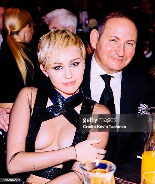 Miley Cyrus and John Dempsey attend amfAR LA Inspiration Gala honoring Tom Ford at Milk Studios on October 29, 2014 in Hollywood, California.