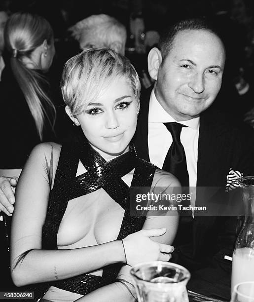 Miley Cyrus and John Dempsey attend amfAR LA Inspiration Gala honoring Tom Ford at Milk Studios on October 29, 2014 in Hollywood, California.