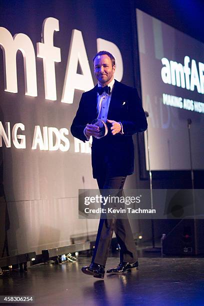 Designer Tom Ford walks off the stage during the amfAR LA Inspiration Gala honoring Tom Ford at Milk Studios on October 29, 2014 in Hollywood,...