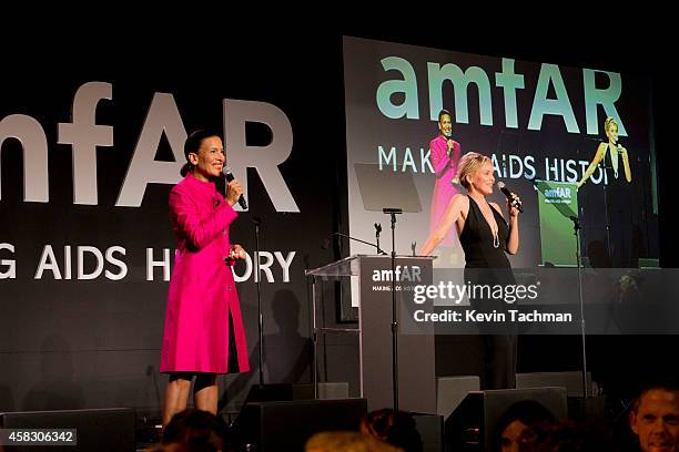 Kristen Davis and Sharon Stone speak on stage during amfAR LA Inspiration Gala honoring Tom Ford at Milk Studios on October 29, 2014 in Hollywood,...