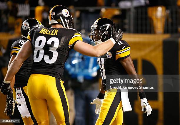 Markus Wheaton of the Pittsburgh Steelers celebrates his touchdown with Heath Miller during the second quarter against the Baltimore Ravens at Heinz...