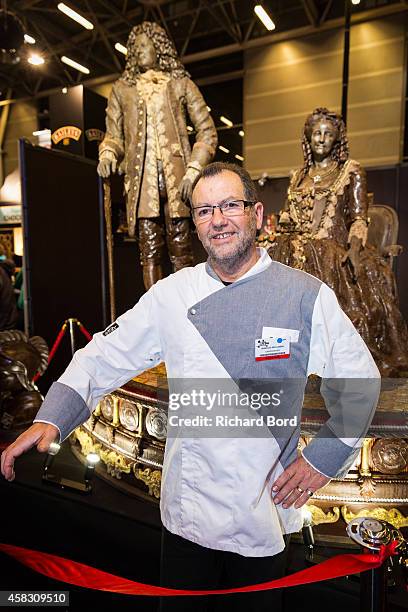 Chocolate maker Jean-Luc Decluzeau poses in a front of his chocolate sculptures before the Fashion Chocolate show at Salon du Chocolat at Parc des...