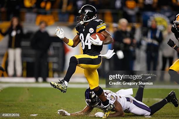 Antonio Brown of the Pittsburgh Steelers avoids a tackle Dominique Franks of the Baltimore Ravens and scores a 54 yard touchdown during the fourth...