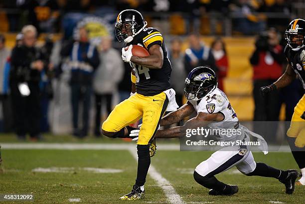 Antonio Brown of the Pittsburgh Steelers avoids a tackle Dominique Franks of the Baltimore Ravens and scores a 54 yard touchdown during the fourth...