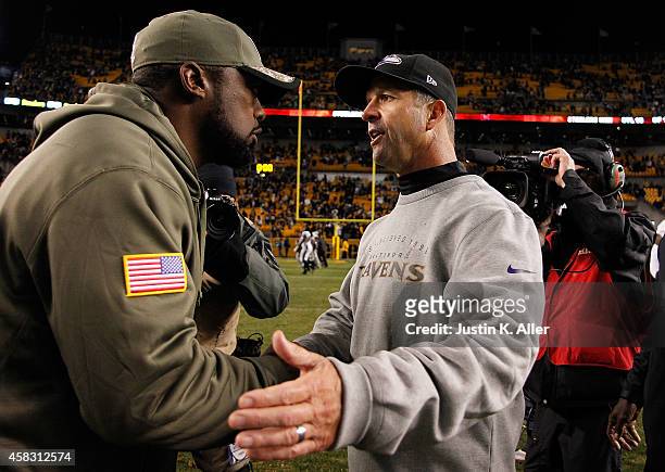 Head coach Mike Tomlin of the Pittsburgh Steelers is congratulated by head coach John Harbaugh of the Baltimore Ravens after Pittsburgh's 43-23 win...