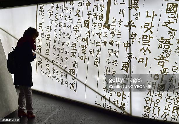 To go with SKorea-NKorea-diplomacy-culture-language by Lim Chang-Won by Lim Chang-Won This picture taken on October 28, 2014 shows a woman looking at...