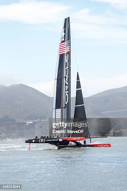 oracle team usa's america's cup catamaran flying downwind - racing catamaran stock pictures, royalty-free photos & images