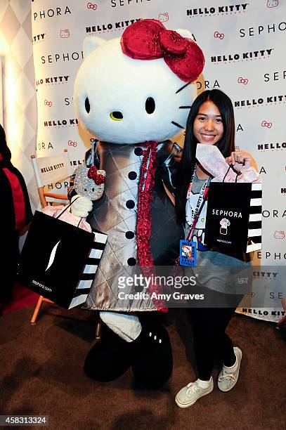 Fans pose for a photo with Hello Kitty at Sephora's First Ever Hello Kitty Beauty Shop at Hello Kitty Con on November 2, 2014 in Los Angeles,...