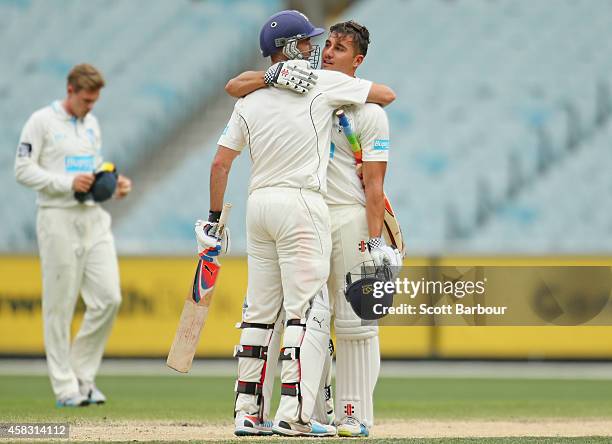 Rob Quiney and Marcus Stoinis of Victoria embrace as they win the match during day four of the Sheffield Shield match between Victoria and New South...