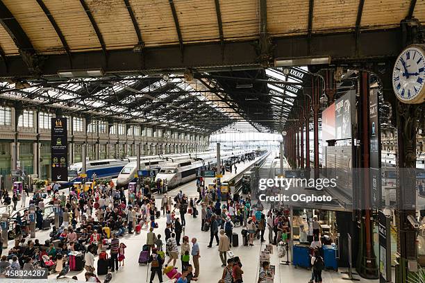 passengers waiting for trains at gare de lyon station - train france stock pictures, royalty-free photos & images