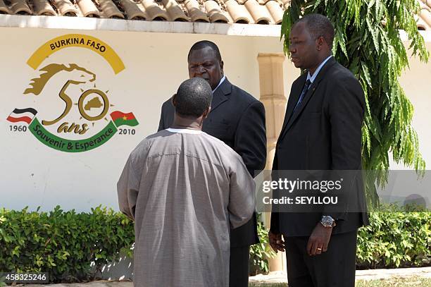 Unidentified Burkinese diplomats stand outside the Burkina Faso embassy in Dakar on November 3 after the African Assembly for the Defense of Human...