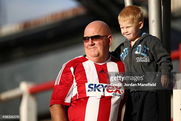 Brentford fans watch on ahead of the Sky Bet Championship match between Brentford and Derby County at Griffin Park on November 1, 2014 in Brentford,...