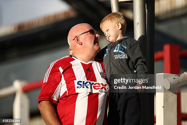 Brentford fans watch on ahead of the Sky Bet Championship match between Brentford and Derby County at Griffin Park on November 1, 2014 in Brentford,...