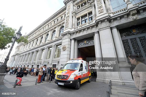 Ambulances carry injured people after fire broke out in a part under construction at Bank of Spain premises in Madrid, Spain on November 03, 2014....