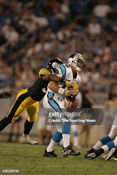 Mike Logan of the Pittsburgh Steelers tackles Chris Weinke of the Carolina Panthers during a game on September 1, 2005 at the Bank of America Stadium...