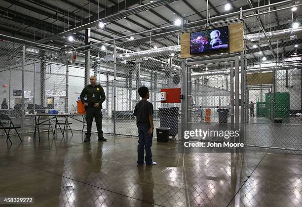 Boy from Honduras watches a movie at a detention facility run by the U.S. Border Patrol on September 8, 2014 in McAllen, Texas. The Border Patrol...