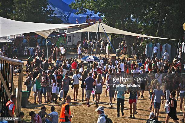 people walking around on roskilde festivalsquare - attending concert stock pictures, royalty-free photos & images