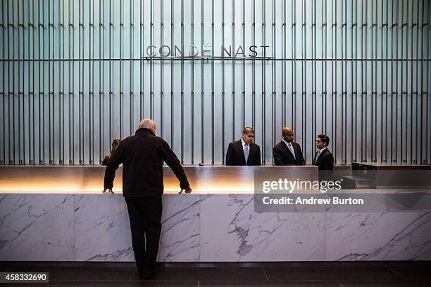 Man checks in to the front desk at One World Trade Center, which opens today, on November 3, 2014 in New York City. The skyscraper is 104 stories...