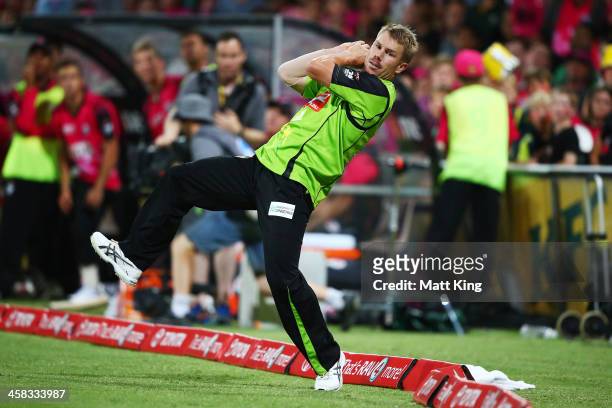 David Warner of the Thunder takes a catch on the boundary to dismiss Michael Lumb of the Sixers during the Big Bash League match between the Sydney...