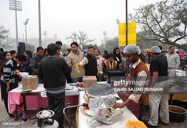 Crowds throng the National Street Food Festival at Jawaharlal Nehru Stadium in New Delhi on December 21, 2013. Over 100 vendors are participating in...