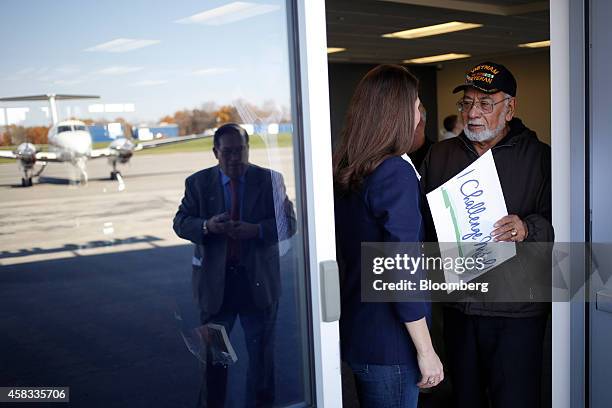 Alison Lundergan Grimes, Democratic candidate for the U.S. Senate, center, speaks with supporter Lou Cabrera after speaking at a campaign stop at the...