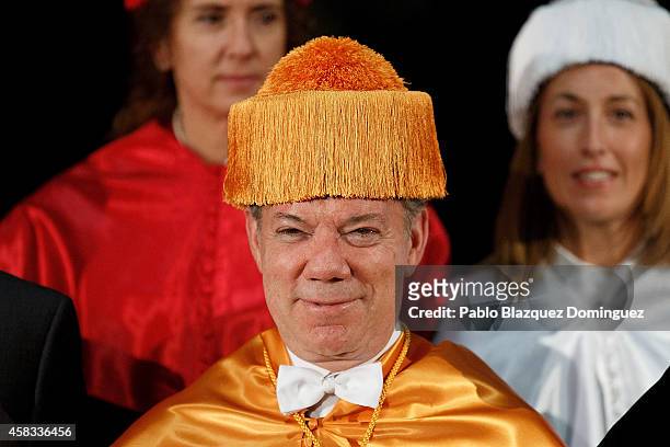 Colombia's President Juan Manuel Santos poses for photographers after receiving an Honorary Doctorate during a ceremony at the Camilo Jose Cela...