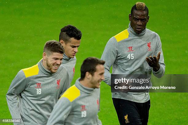 Mario Balotelli of Liverpool FC exercises with team-mates Javier Manquillo , Alberto Moreno and Philippe Coutinho during the training session ahead...