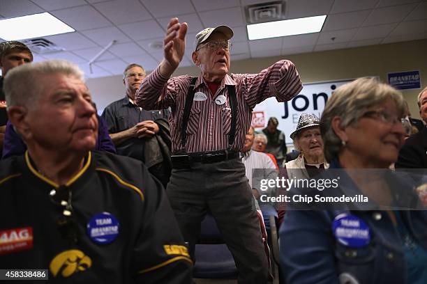 Dale Petersen of Iowa City stands up and shouts, "If the Democrats call this a war on women then I say bring it on!" during a rally with Republican...