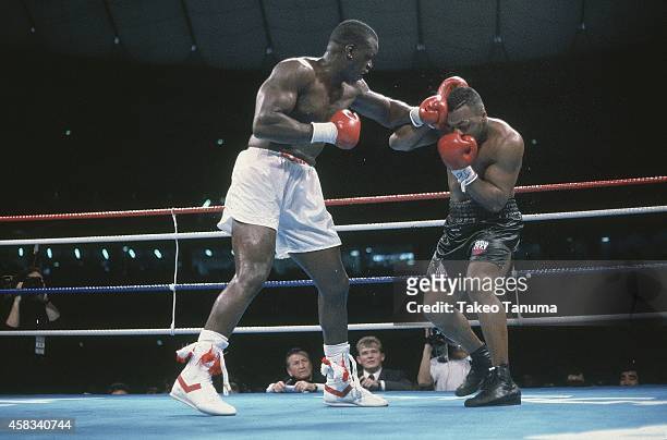 Heavyweight Title: James Buster Douglas in action, throwing punch vs Mike Tyson at Tokyo Dome.Tyson is defeated by Douglas by 10th round knockout for...