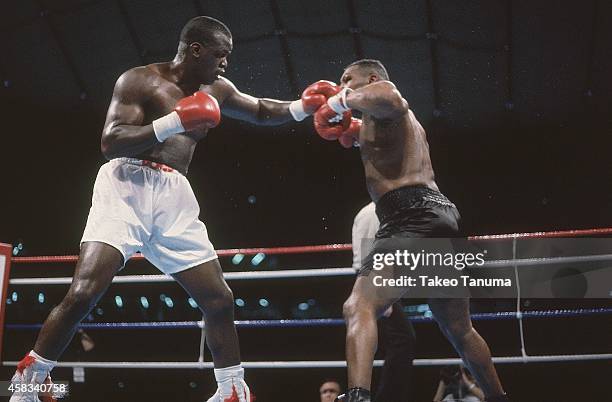 Heavyweight Title: James Buster Douglas in action, throwing punch vs Mike Tyson at Tokyo Dome.Tyson is defeated by Douglas by 10th round knockout for...