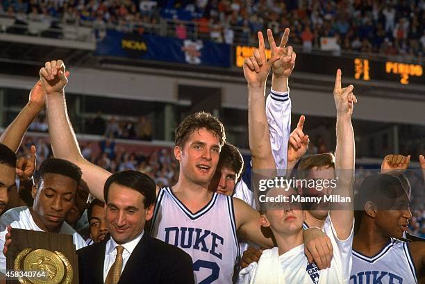 Final Four: Duke head coach Mike Krzyzewski, Christian Laettner , Bobby Hurley , and teammates victorious with trophy after winning National...