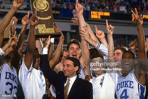Final Four: Duke head coach Mike Krzyzewski, Christian Laettner , Bobby Hurley , and teammates victorious with trophy after winning National...