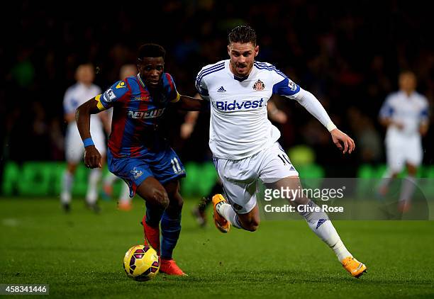 Connor Wickham of Sunderland is closed down by Wilfried Zaha of Crystal Palace during the Barclays Premier League match between Crystal Palace and...